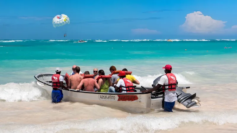 A parasail canopy over a turquoise tropical bay