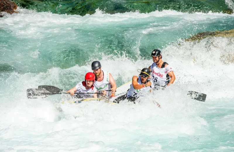 A team rafting through white-water rapids