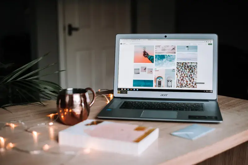 A solo traveller working on a laptop planning a trip