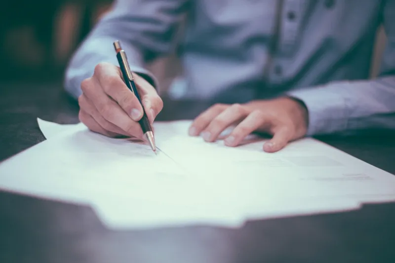 Paperwork being completed for a visa application